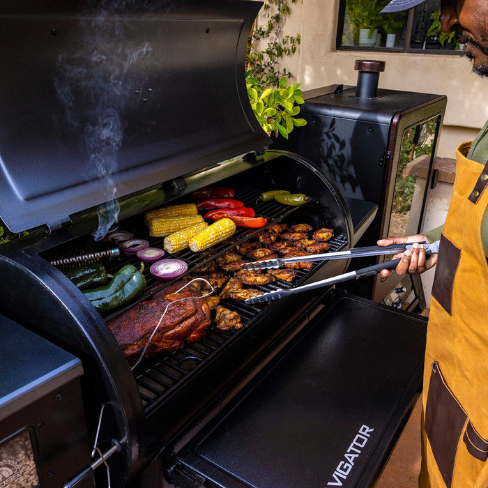 Pit Boss navigator grill with a variety of meat and vegetables 
