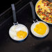 Black Pit Boss egg rings cooking sunny-side-up eggs on a stovetop.