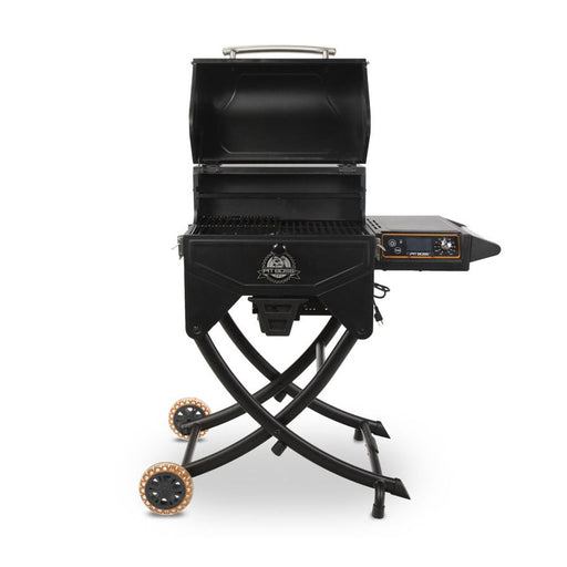 Portable black pellet grill with folding legs, side control panel, and two large wheels for easy transport.