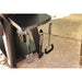 "Black Pit Boss BBQ tools hanging from a grill, including a spatula, tongs, and brush."