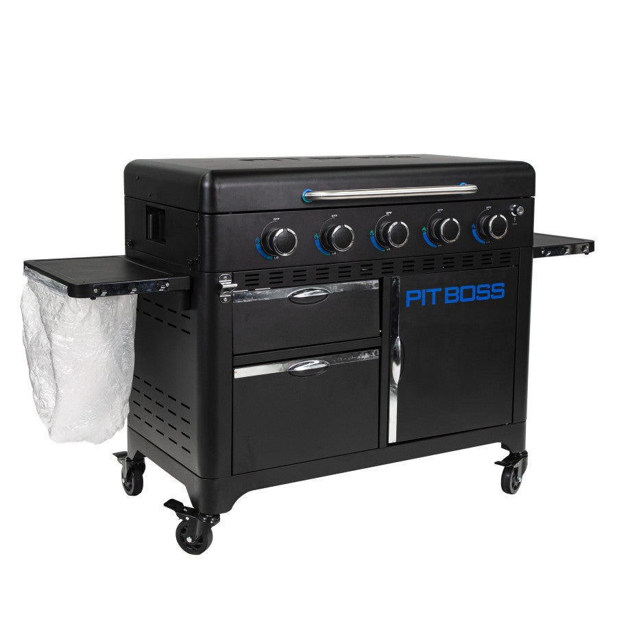 lifestyle_4, Black griddle with bright blue and silver accents with large blue "pit boss" logo. Shown with trash bag holder and trash bag