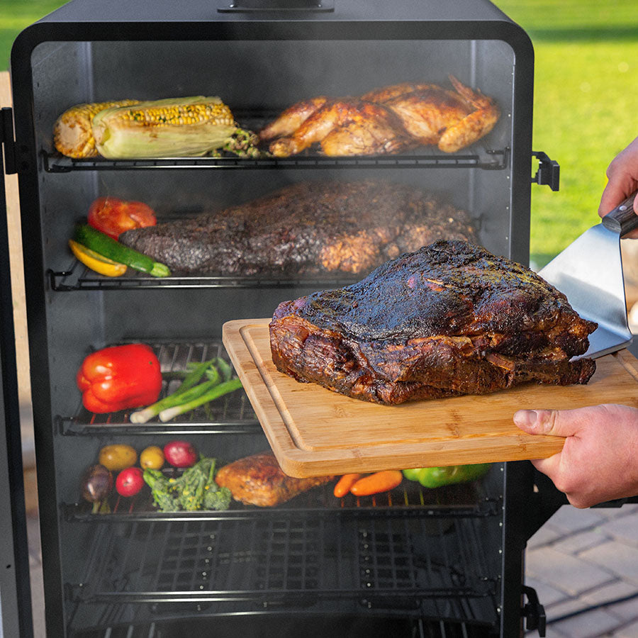Pit Boss Navigator 3 Series Vertical Smoker, removing smoked brisket from smoker with other grilled meats and veggies