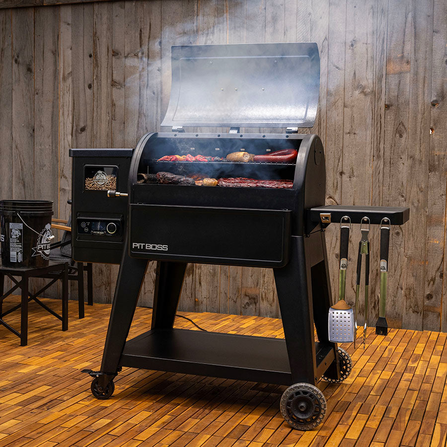 Pit Boss Navigator 850M Wood Pellet Grill smoking food in backyard patio