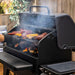 Pit Boss Navigator 1600 Wood Pellet Grill, open grill with smoking food on backyard patio
