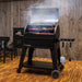 Pit Boss Navigator 850M Wood Pellet Grill smoking food in backyard patio