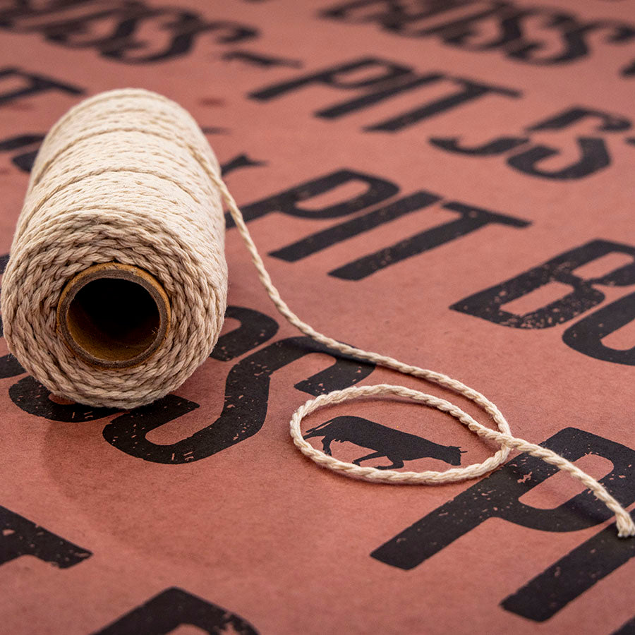 Pit Boss BBQ Twine, white cotton rope for bbq prep, 200 feet, resting on pit boss butcher paper