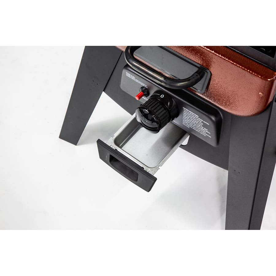 red and black vertical smoker with white pit boss logo and lettering. up close of grease cathcher