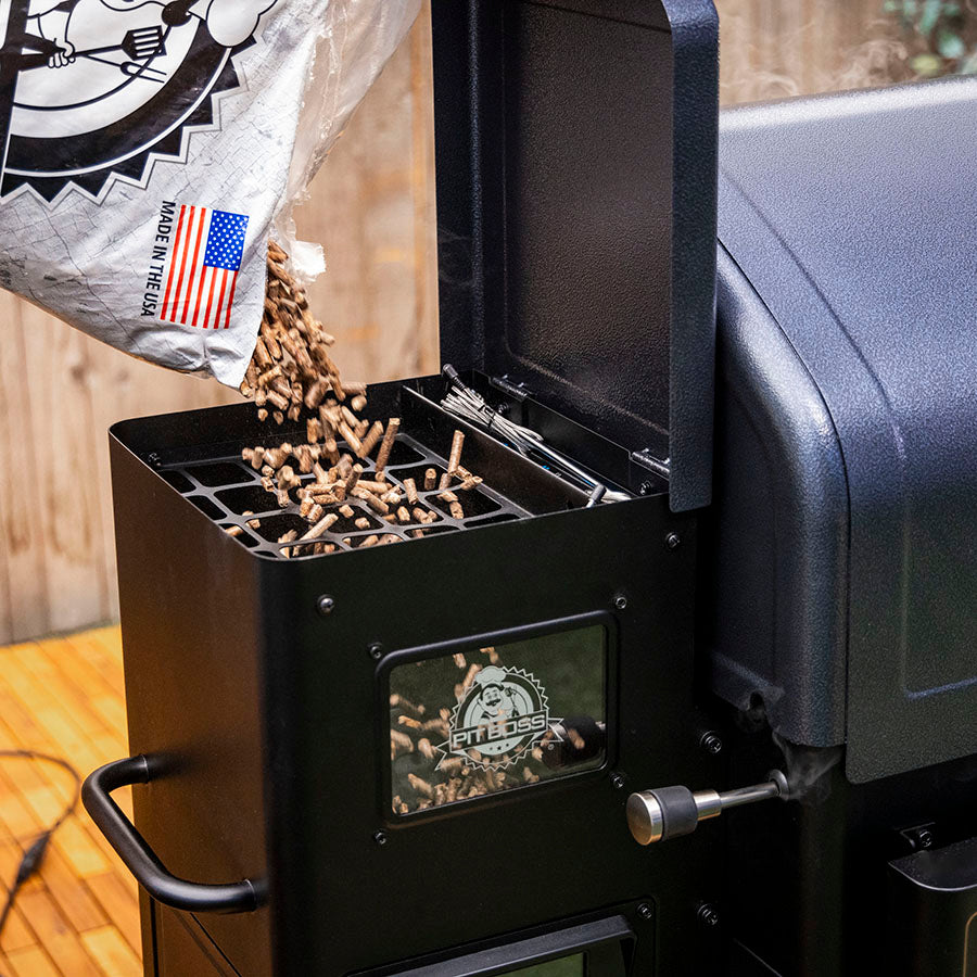 Pit Boss Navigator 1300M Wood Pellet Grill, pouring hardwood bbq pellets into 30 pound hopper with viewing window