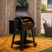 Pit Boss 700FB2 Wood Pellet Grill with meats, ribs, and veggies grilling in backyard patio