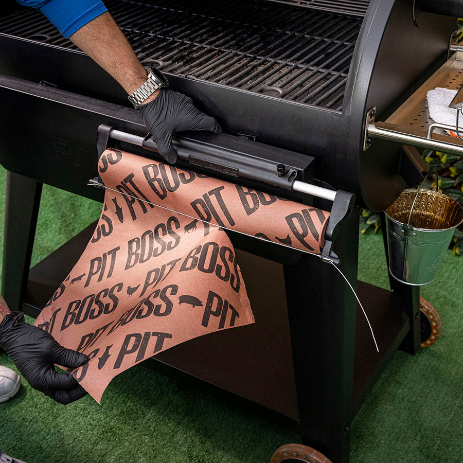 Pit Boss Magnetic Butcher Paper Holder for BBQ Grills and Smoker Upgrade Attachment, magnetized to front of grill, hand tearing butcher paper