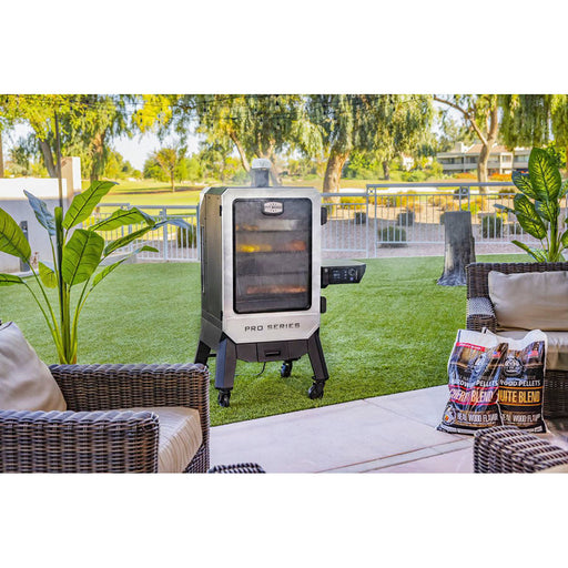Vertical smoker standing in a backyard with meats and veggies being smoked within the Pit Boss smoker. Pit Boss pellets displayed on the side.