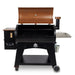 lifestyle_1, Orangeish-brown and black grill with silver accents and Pit Boss logo. Grill hood open