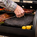 Pit Boss Carbon Series 700 wood pellet grill shown from a front angled view with lid open, displaying cooking grates, grilling surface, and meat probes