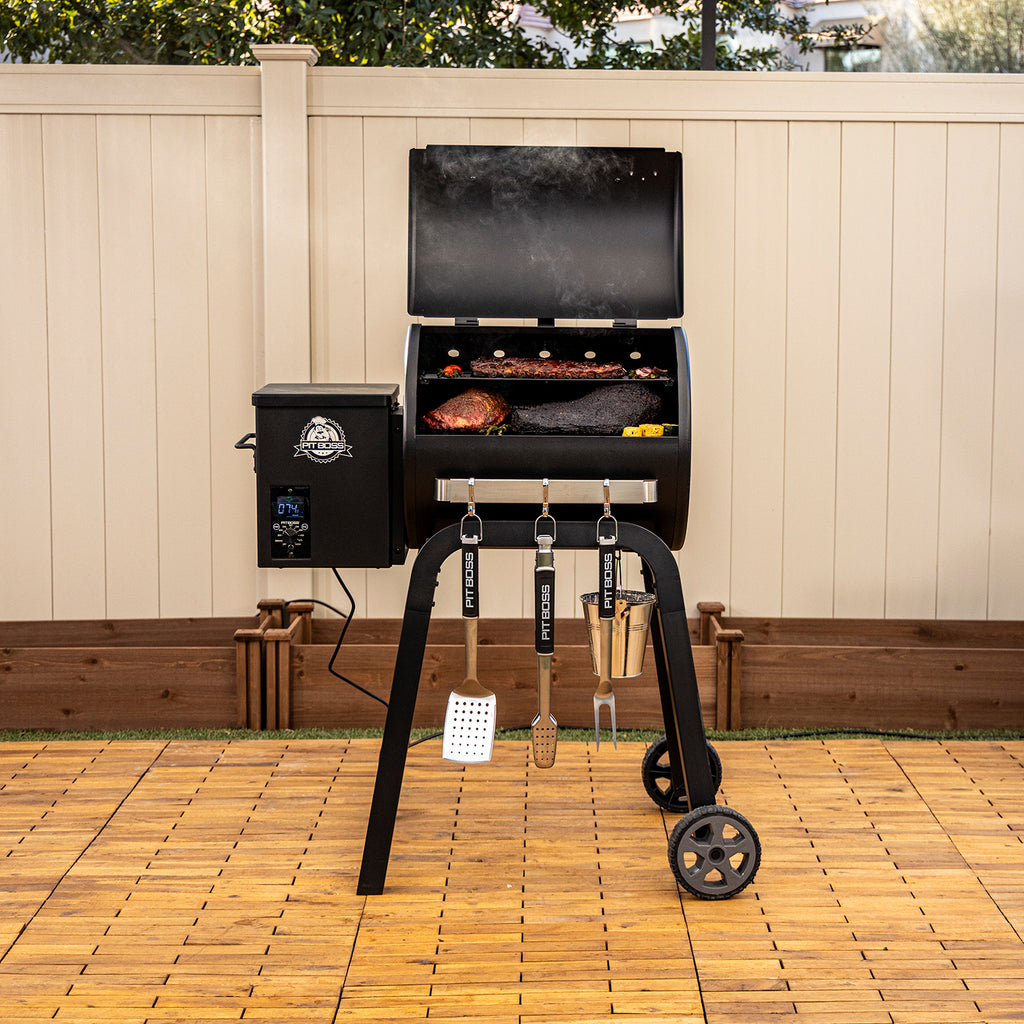 Pit Boss Carbon Series 500 wood pellet grill shown from front angle with lid open, revealing cooking racks