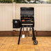 Pit Boss Carbon Series 500 wood pellet grill shown from front angle with lid open, revealing cooking racks