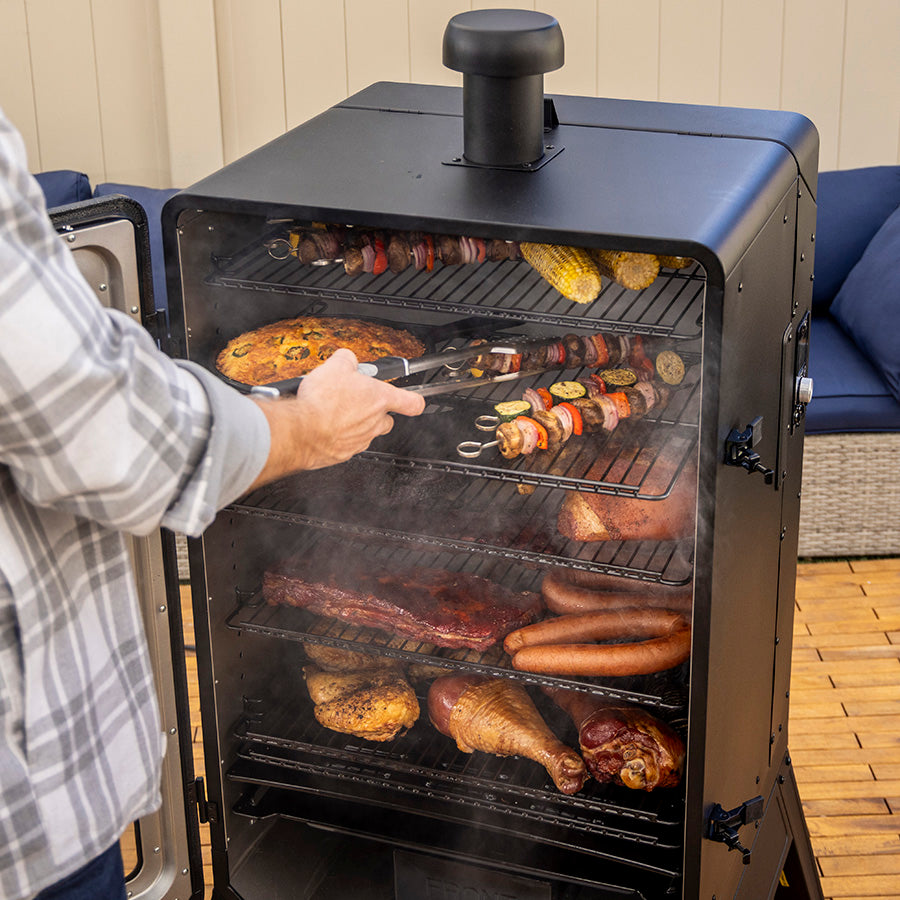 Pit Boss Sportsman 7-Series Vertical Wood Pellet Smoker, man smoking bbq food on smoker, chicken, veggies, beef