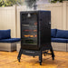 Pit Boss Sportsman 7-Series Vertical Wood Pellet Smoker on backyard patio with food smoking inside
