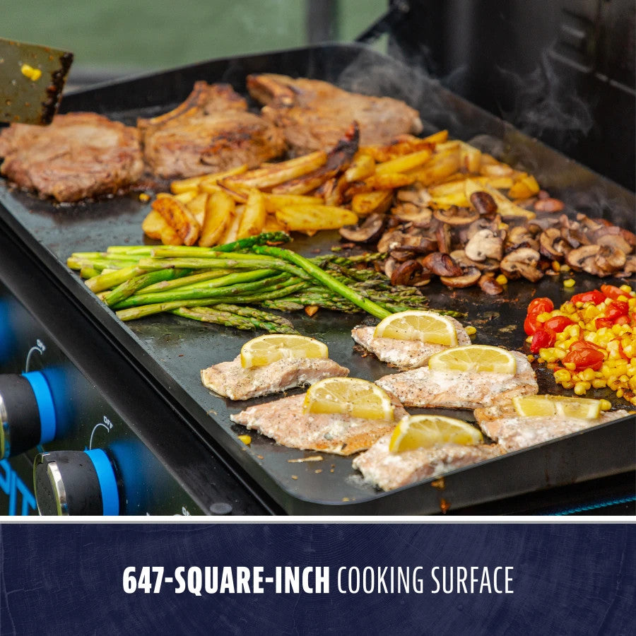 lifestyle_3, Black griddle with bright blue and silver accents and a large blue Pit Boss logo on front. Side angle view. Grill hood open