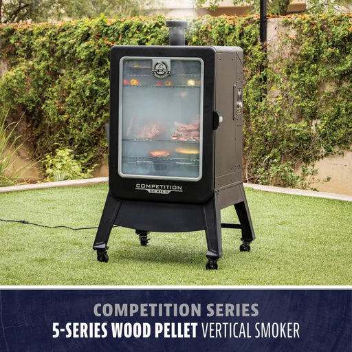 Pit Boss Grills Competition Series PBV5P2 Vertical Smoker, black, with glass window showing meats cooking inside.