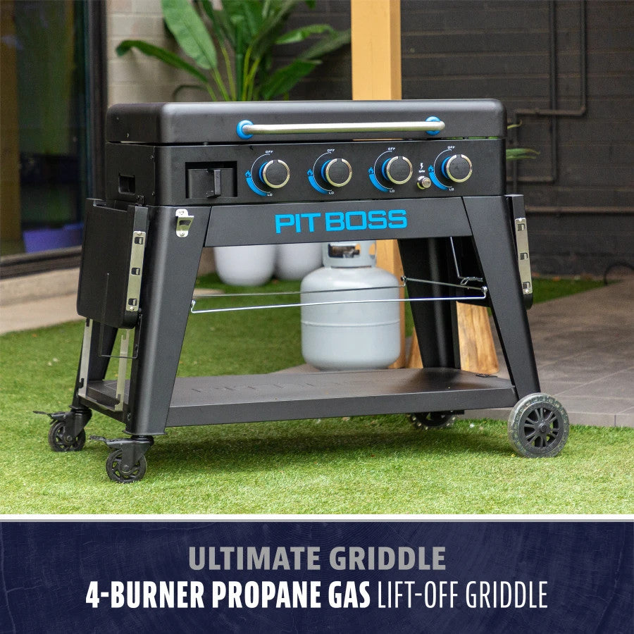 Black Pit Boss 4-Burner Ultimate Lift-Off Griddle on wheels, with propane tank and storage shelf.