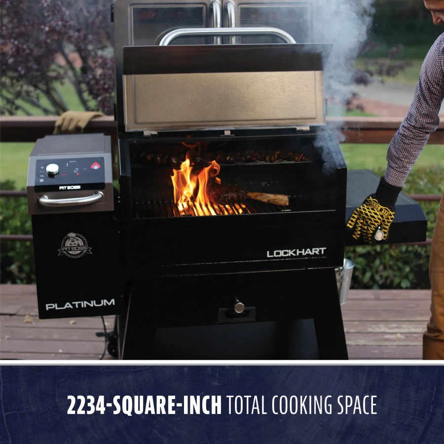 lifestyle_2, Silver and black grill/smoker with Pit boss logo and white lettering. Shown on backyard porch with meat and veggies inside