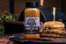 Pit Boss Cowboy Butter Rub in front of a burger on butcher paper