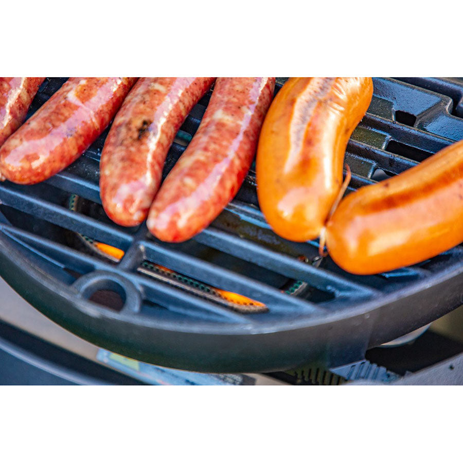 Black grill with sausages cooking.