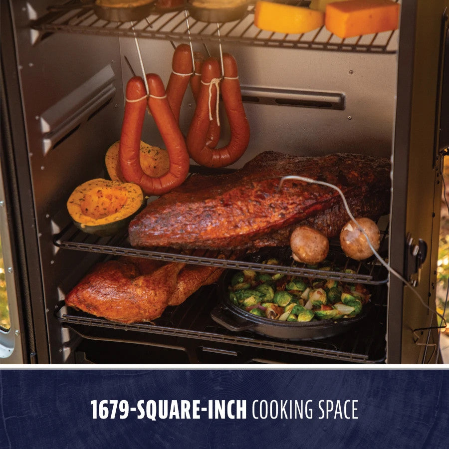 "Black smoker with 1679-square-inch cooking space, holding meats, vegetables, and sausages."