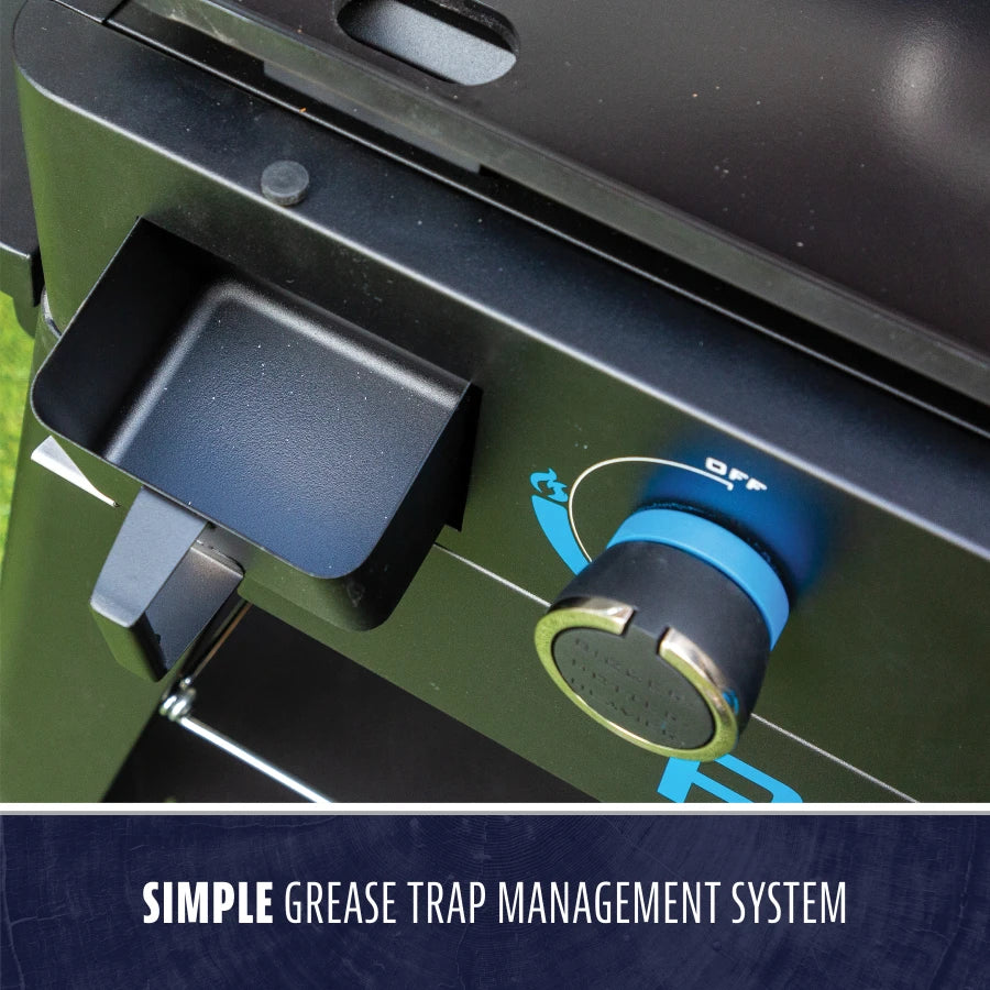 Close-up of a grill’s simple grease trap system with a blue control knob and easy-access grease tray.