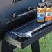 Black Pit Boss grill with Prime Beef and Boss Rub seasoning jars and spatula.