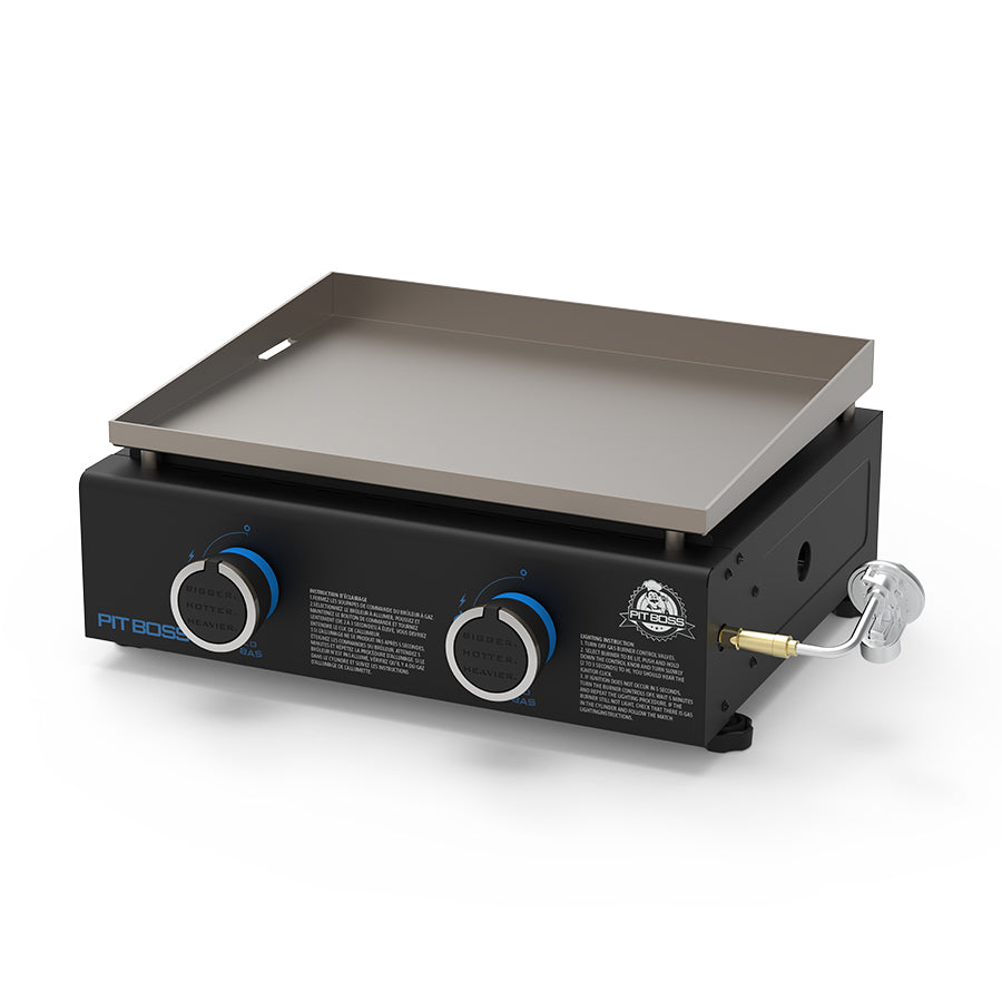 Portable tabletop griddle with two control knobs, flat cooking surface, and black base. Ideal for outdoor grilling.