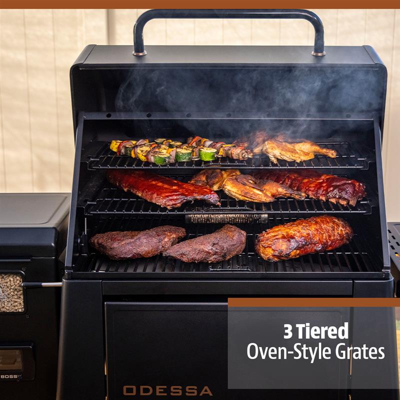 Black Odessa 3-tiered oven-style grates grill with smoking meats and vegetables.
