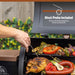 Black Boss electric grill with meat probe, cooking chicken and vegetables.
