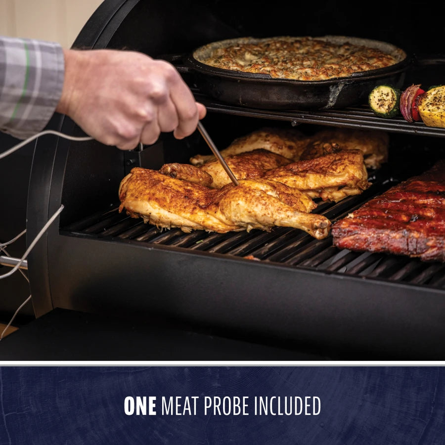 Black electric grill with chicken, ribs, and vegetables cooking, includes one meat probe.