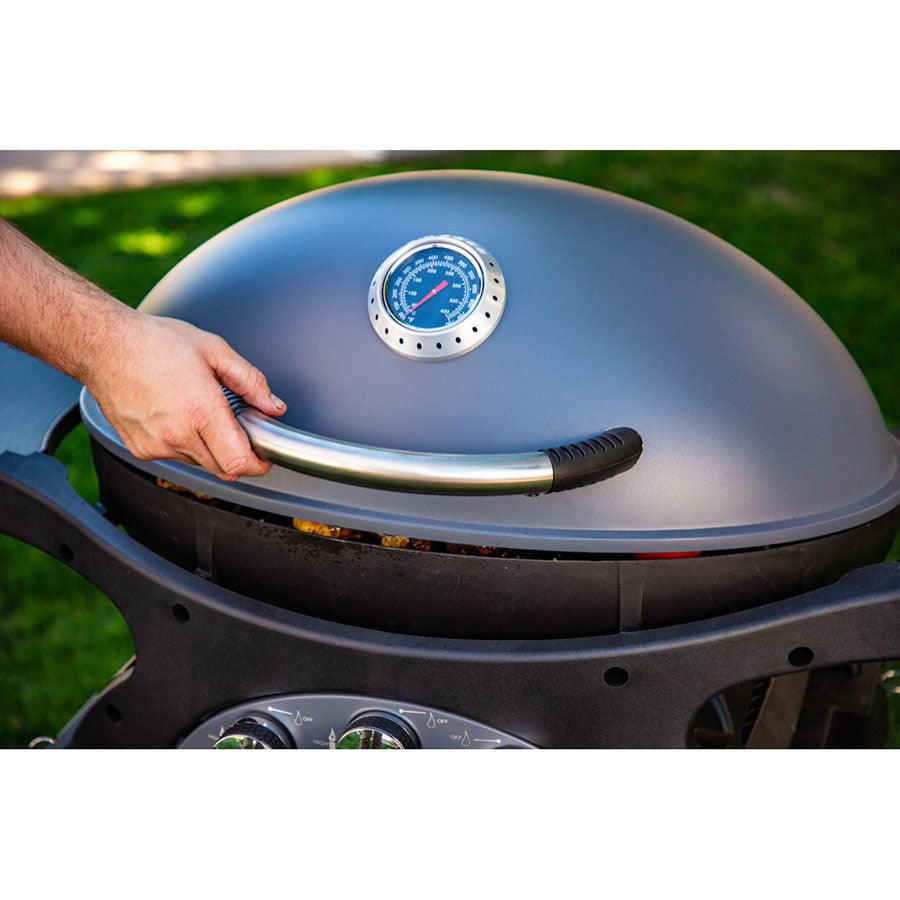 Gray dome-shaped grill with built-in thermometer and hand opening lid.
