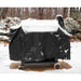 Black outdoor grill cover with wheels, snow-covered in winter setting.