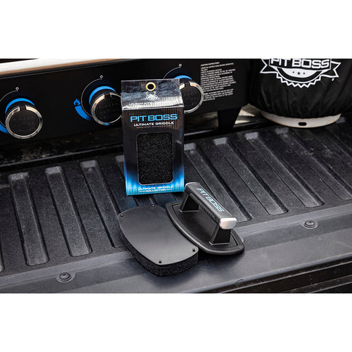Blue Pit Boss Ultimate Griddle in packaging, shown on truck bed.