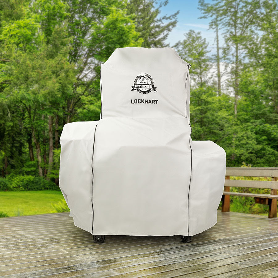 White Lockhart outdoor chair cover on wheels, green background.