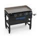 Black Pit Boss flat-top grill with four control knobs and wheels.