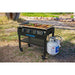 Black Pit Boss outdoor grill with propane tank, cooking vegetables and meat.