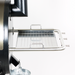 Silver espresso machine drip tray with perforated design and handle.