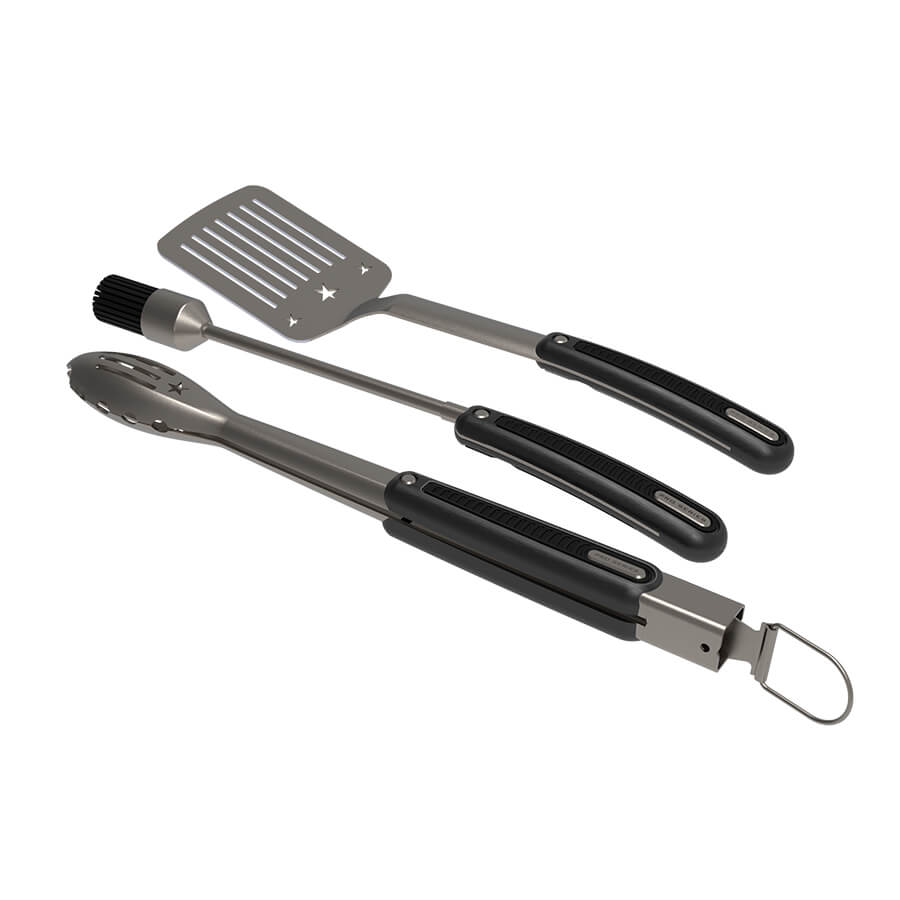 "Set of black and silver kitchen tools: spatula, tongs, and brush."