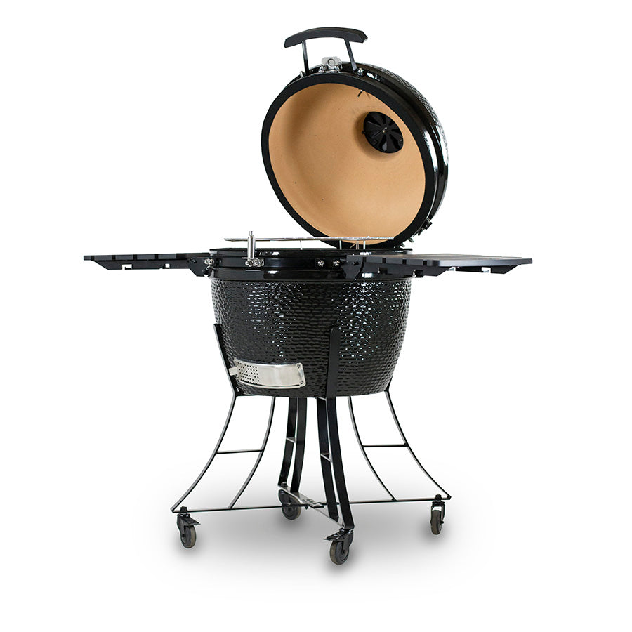 Black kamado-style grill with dome lid and side shelves on a stand with wheels.
