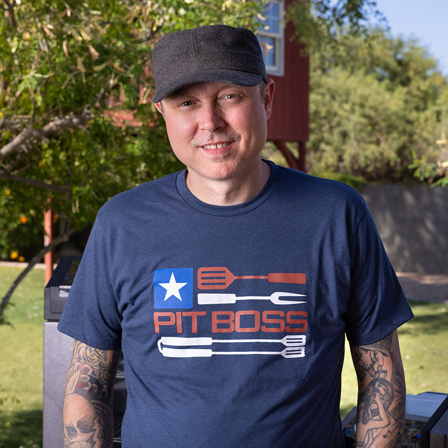 Navy blue "PIT BOSS" t-shirt with American flag design and barbecue tools graphic.