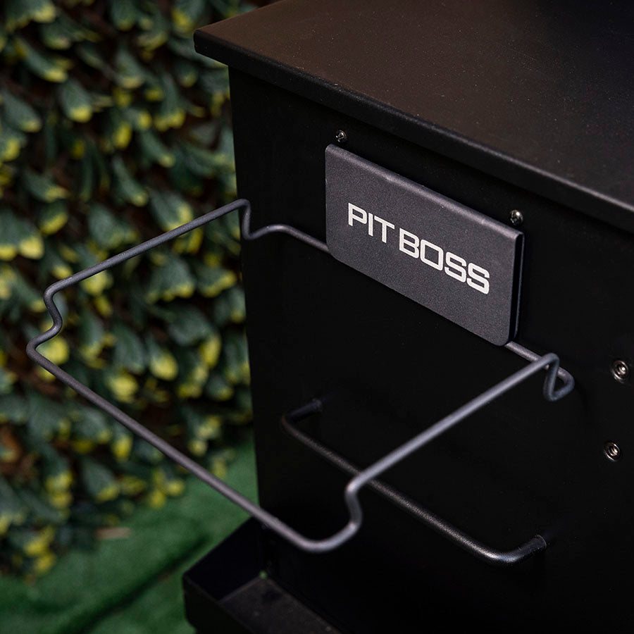 Black Pit Boss grill with metal wire rack and control panel.