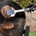 Black Pit Boss spatula lifting steak on grill.