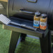 Black Boss BBQ grill with seasoning jars and spatula on side tray.
