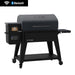 Pit Boss pellet grill with Bluetooth and Wi-Fi, black finish, side shelf, digital control panel, and caster wheels.