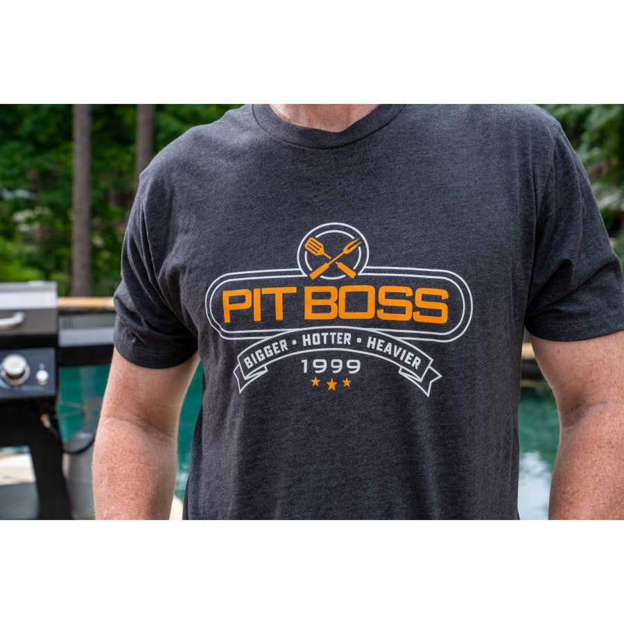 Dark gray Pit Boss t-shirt with "Bigger · Hotter · Heavier 1999" design.
