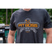 Dark gray Pit Boss t-shirt with "Bigger · Hotter · Heavier 1999" design.